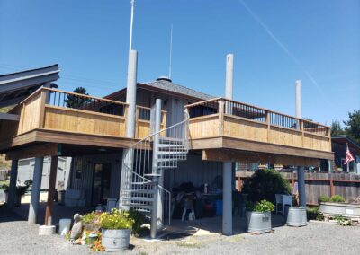 Americana deck with custom rail for partial privacy and spiral staircase in Bodega Bay, CA