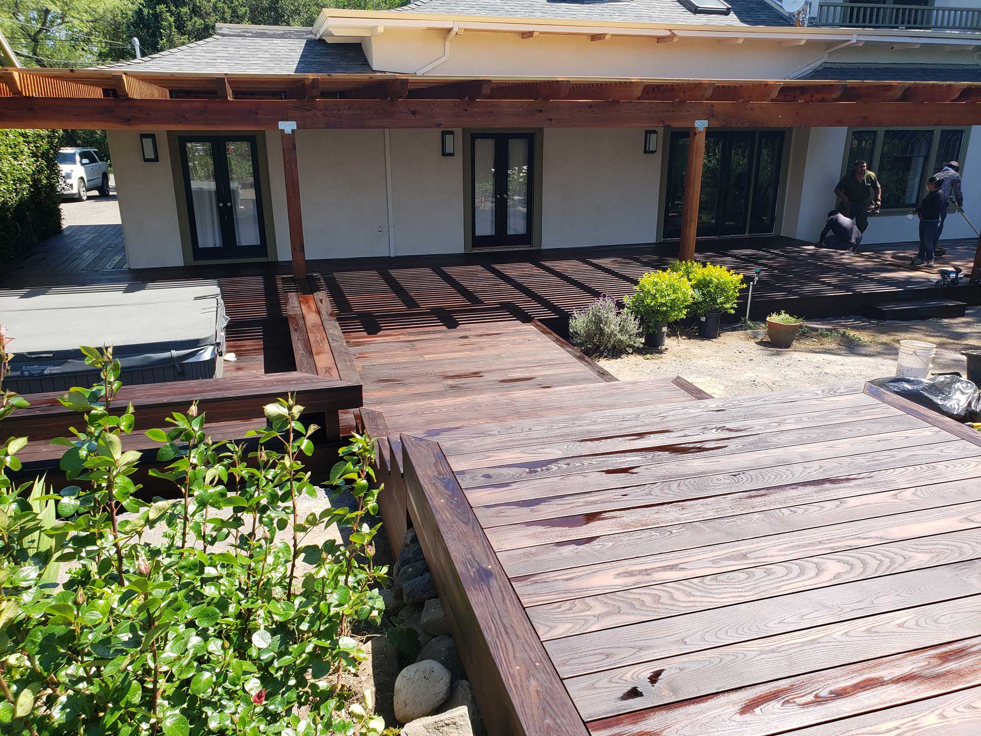 Americana oak deck with cedar patio cover and custom corbels including a bench around a hot tub in Healdsburg, CA