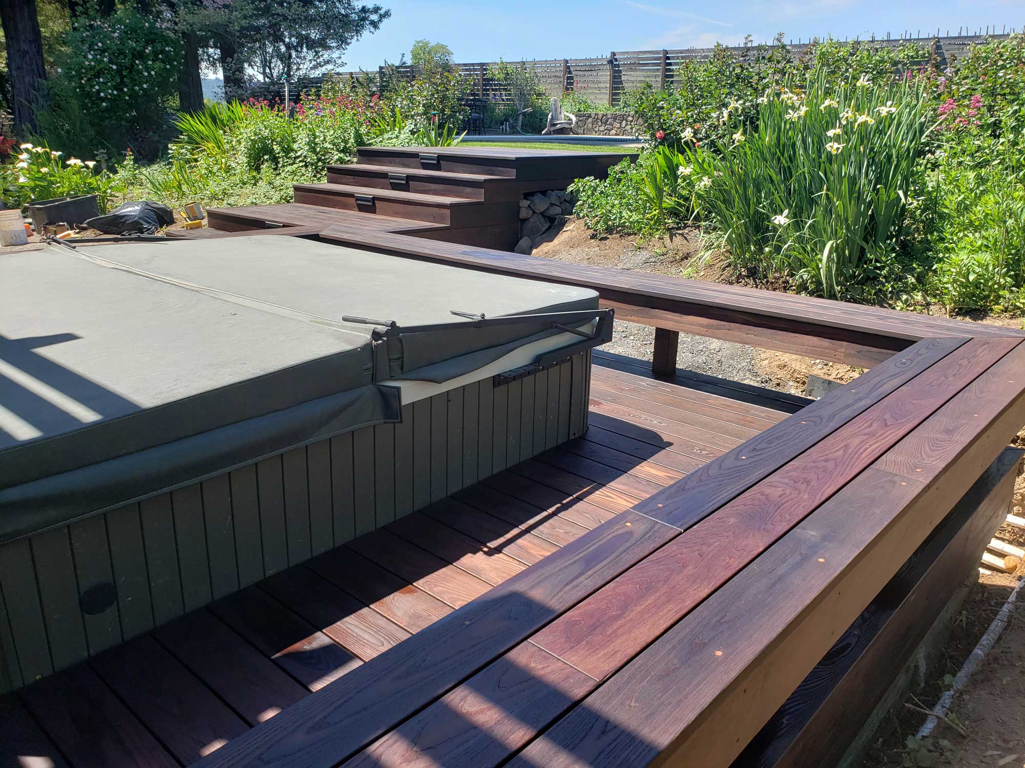 Americana oak deck with cedar patio cover and custom corbels including a bench around a hot tub in Healdsburg, CA